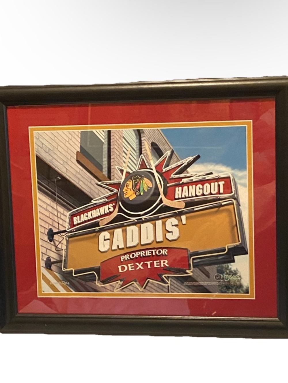 18 x 16” framed poster of Chicago Blackhawks hockey team "Gaddis' Hangout" sign.